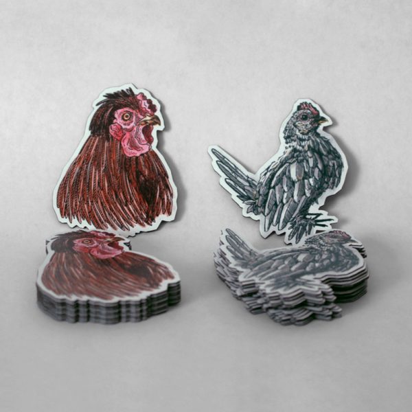 Two rooster magnets on display